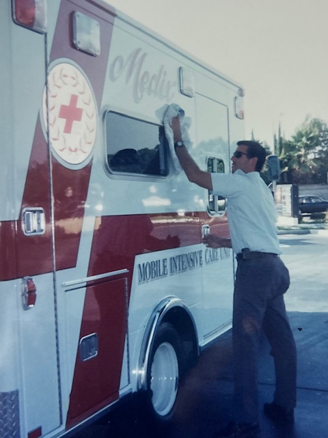 Michael Dimas polishing the side of a Medix Mobile Intensive Care Unit ambulance — the pride of ownership visible in every detail